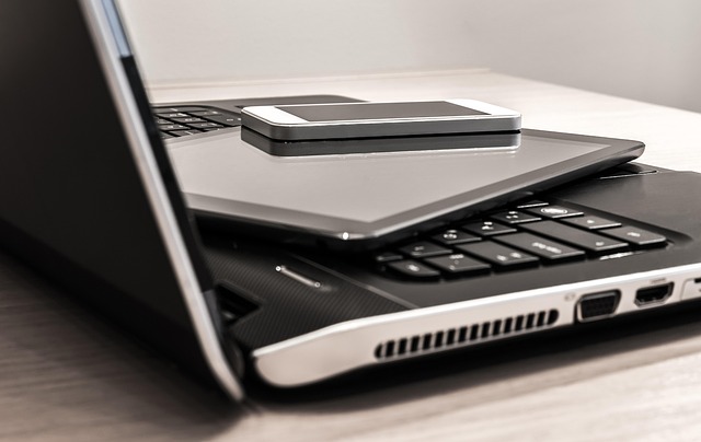 laptop computer being repaired with performance diagnostic tools on screen